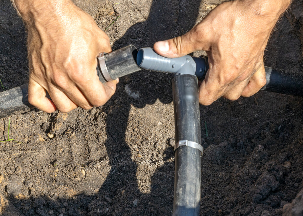 Installing a standard underground sprinkler T fitting using standard size tubing and crimps